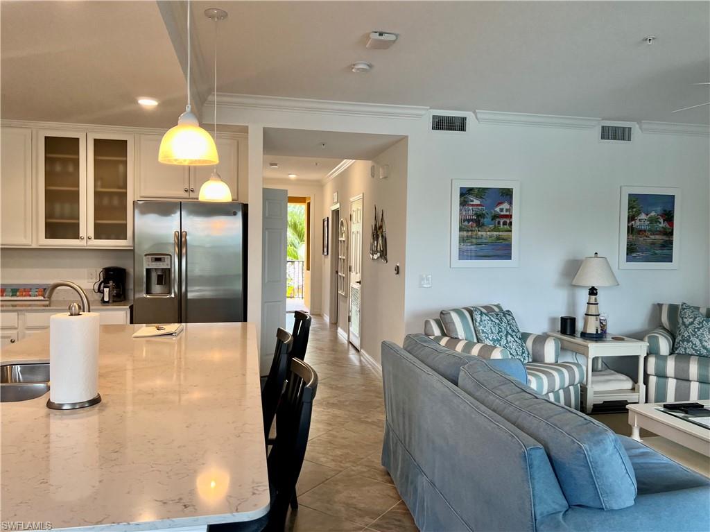 9584 Trevi Court, Unit 5223 Naples, FL 34113 - Photo 14 of 42 a living room with furniture and a chandelier
