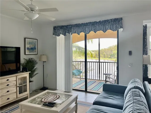 a kitchen with stainless steel appliances granite countertop a refrigerator a stove a sink a dining table and chairs