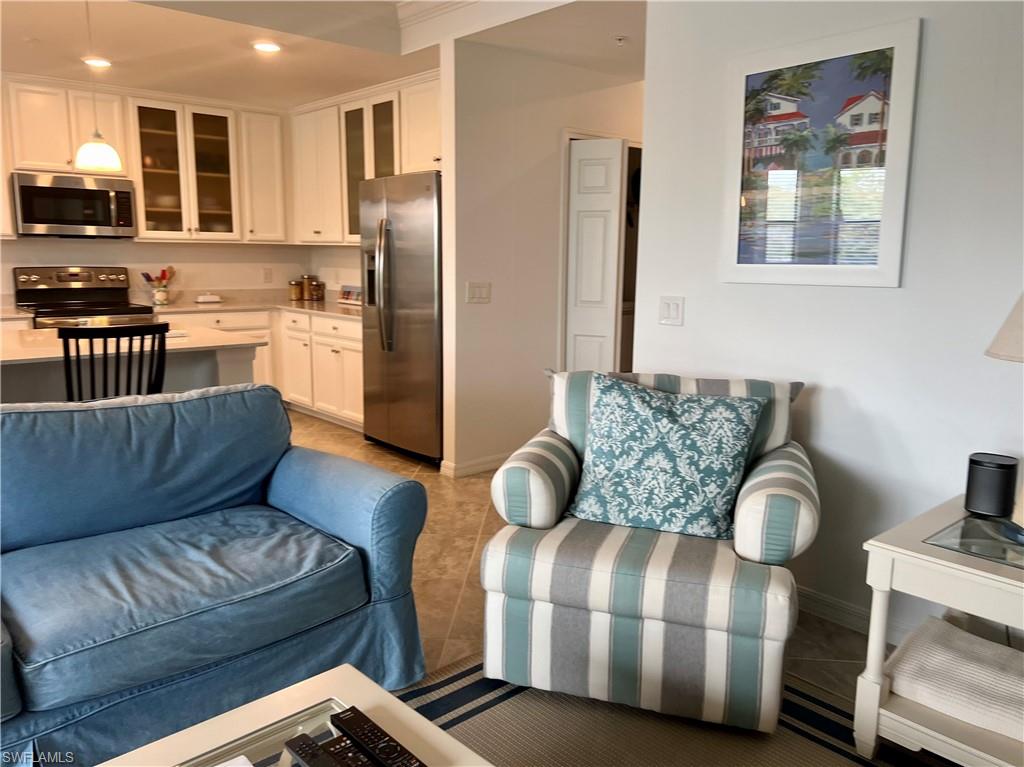 9584 Trevi Court, Unit 5223 Naples, FL 34113 - Photo 22 of 42 a living room with furniture and kitchen view