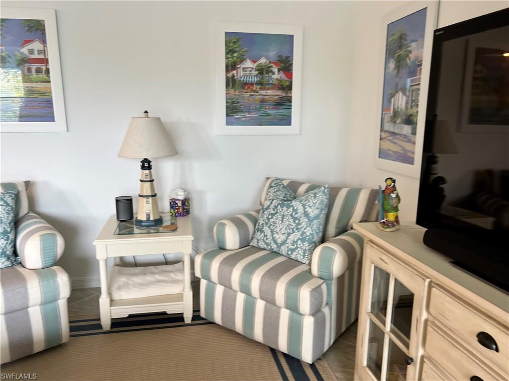 9584 Trevi Court, Unit 5223 Naples, FL 34113 - Photo 23 of 42 a living room with furniture and a flat screen tv