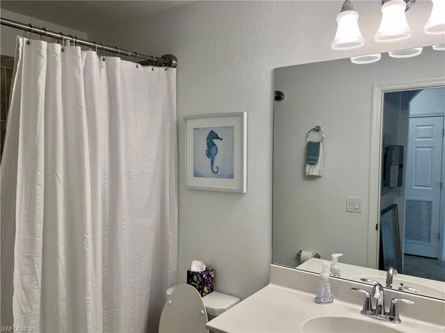 a bathroom with a shower curtain and a curtain