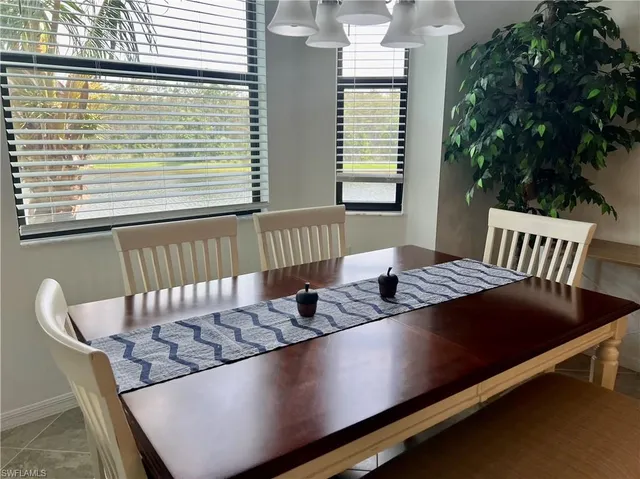 a dining room with furniture and a chandelier