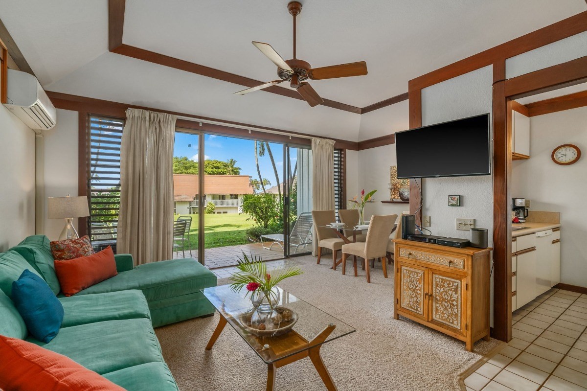 2253 Poipu Road, Unit 85 Koloa, HI 96756 - Photo 3 of 13 a living room with furniture a flat screen tv and a window