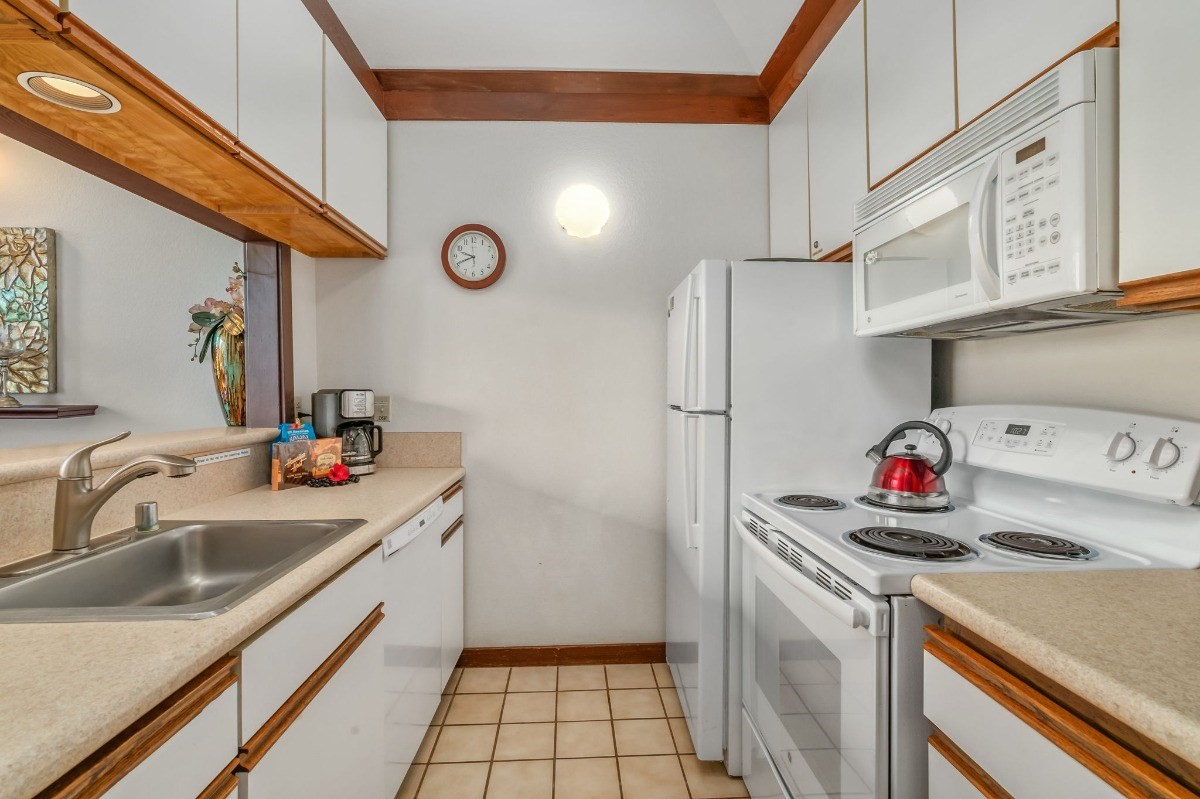 2253 Poipu Road, Unit 85 Koloa, HI 96756 - Photo 6 of 13 a kitchen with a sink cabinets and appliances