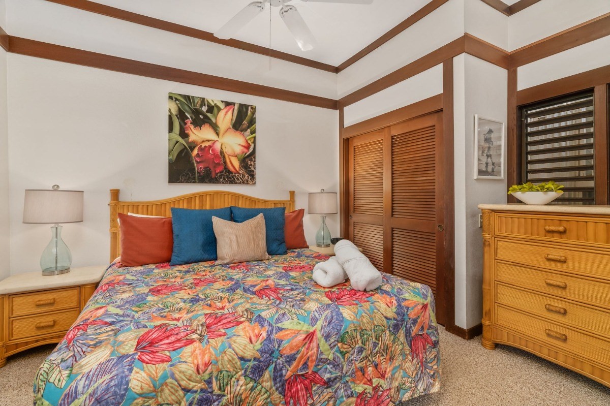 2253 Poipu Road, Unit 85 Koloa, HI 96756 - Photo 8 of 13 a bedroom with a bed and a cabinets