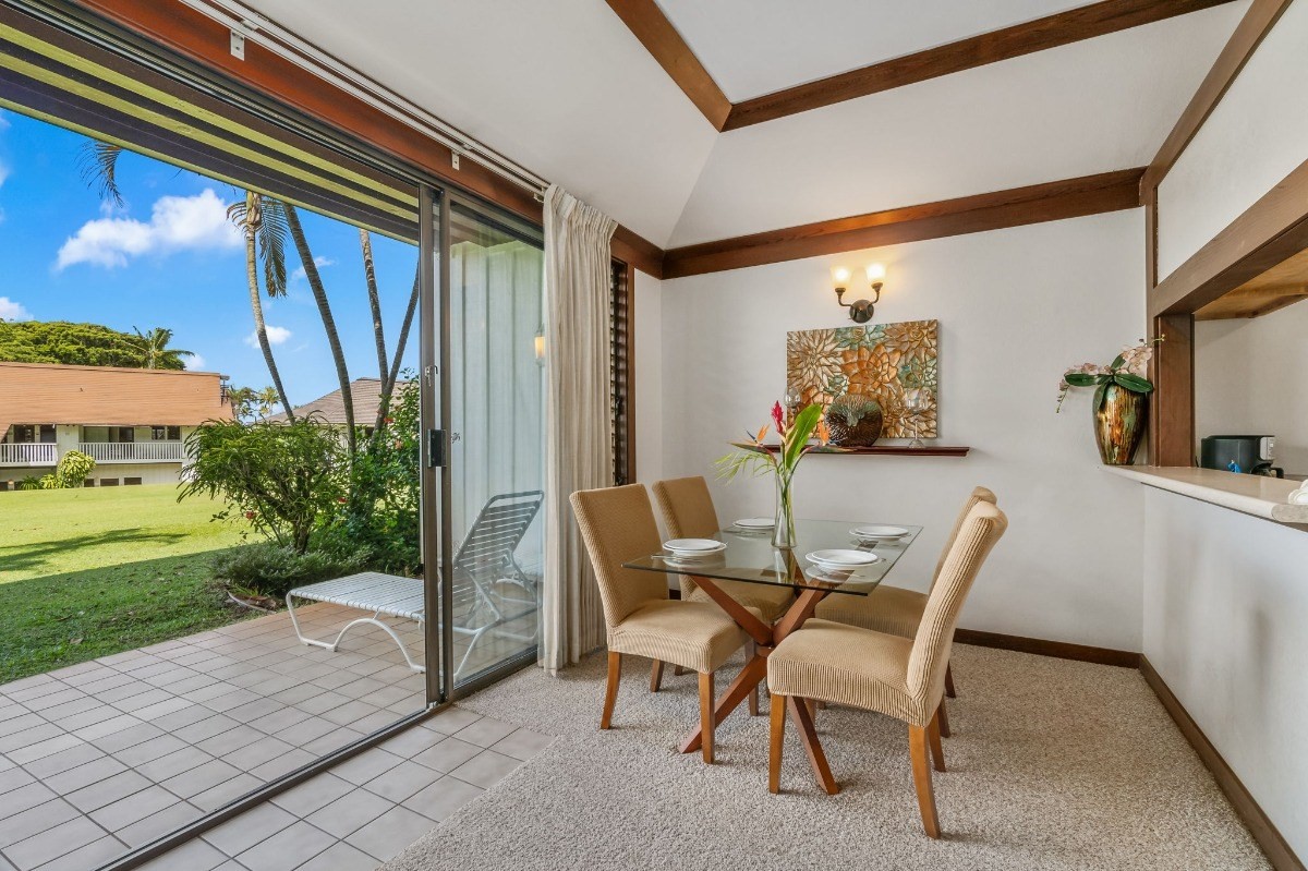 2253 Poipu Road, Unit 85 Koloa, HI 96756 - Photo 10 of 13 a view of a patio with a table and chairs