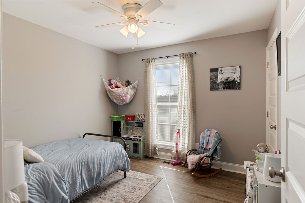 123 Timber Rdg Drive Pulaski, TN 38478 - Photo 14 of 20 a bedroom with a bed and a chandelier