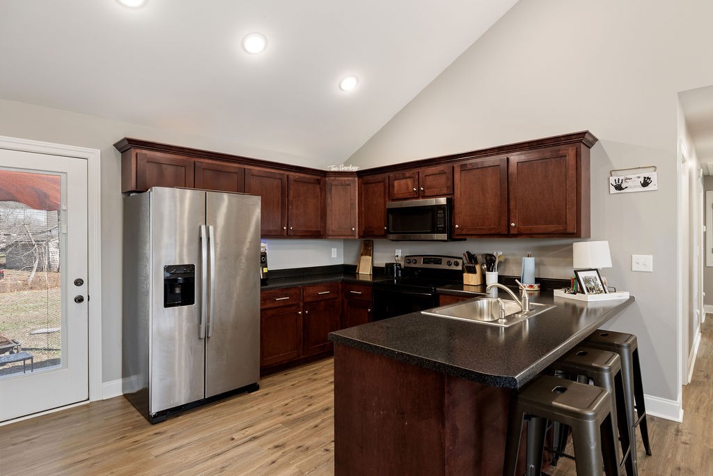 123 Timber Rdg Drive Pulaski, TN 38478 - Photo 5 of 20 a kitchen with stainless steel appliances a refrigerator a sink a stove a microwave and wooden cabinets