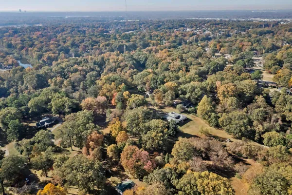 an aerial view of residential houses with city view