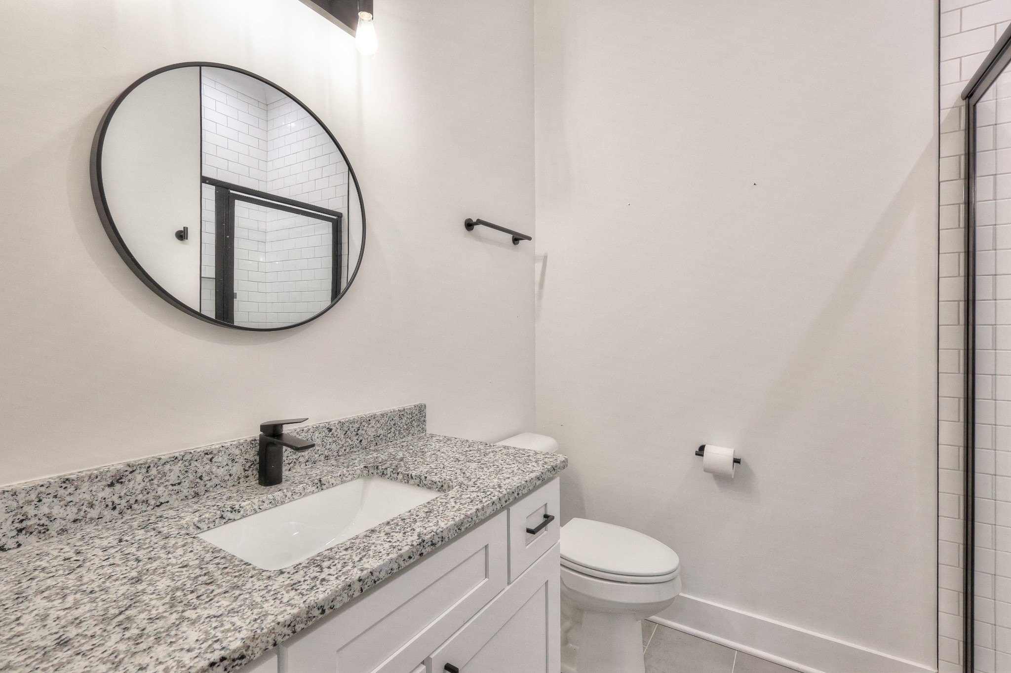 1181 Norton Road Manchester, TN 37355 - Photo 29 of 51 a bathroom with a granite countertop toilet a sink and a mirror