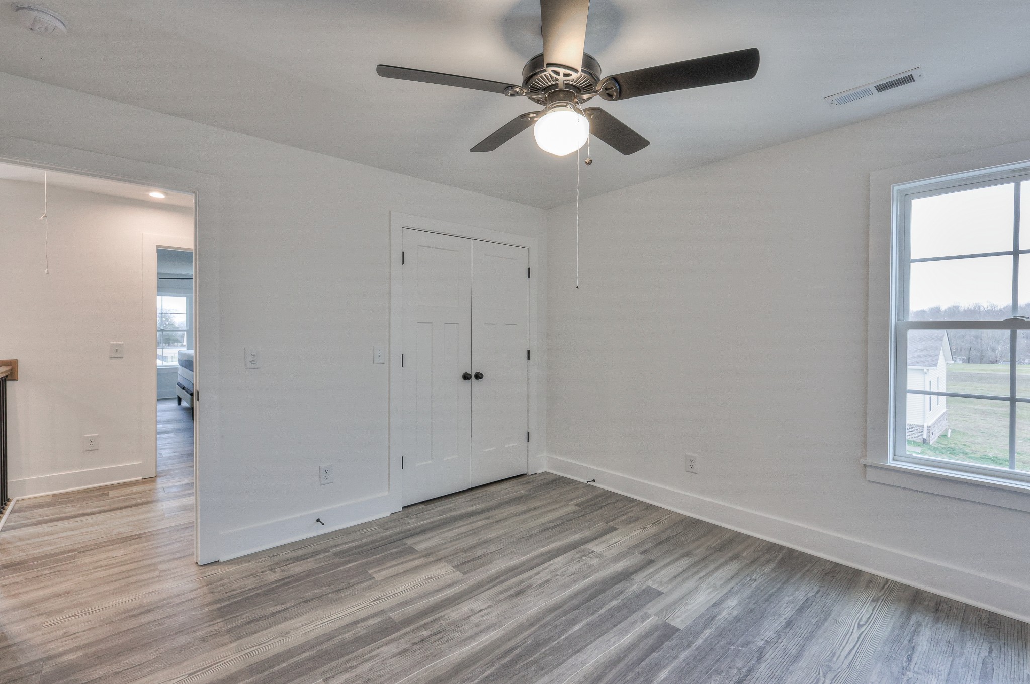 1181 Norton Road Manchester, TN 37355 - Photo 35 of 51 an empty room with wooden floor fan and windows