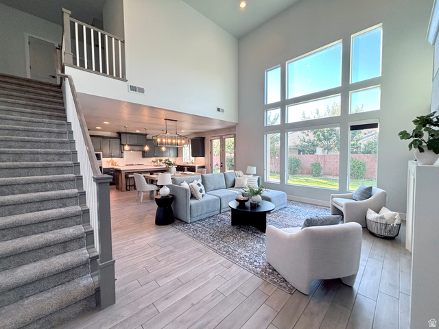 429 East Treasure Road Washington, UT 84780 - Photo 3 of 20 Open concept living area featuring wood-finish flooring and a staircase with gray carpeting