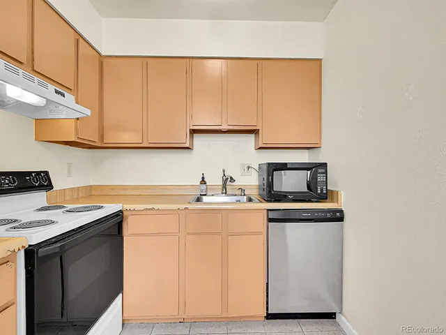 a kitchen with stainless steel appliances granite countertop a sink and a stove