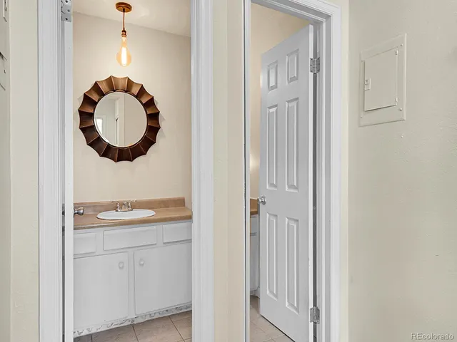 a bathroom with a granite countertop sink and mirror