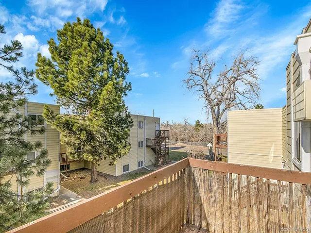 a view of a balcony with a tree