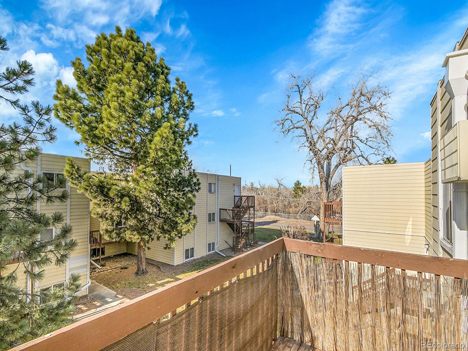 9340 West 49th Avenue, Unit 218 Wheat Ridge, CO 80033 - Photo 19 of 31 a view of a balcony with a tree