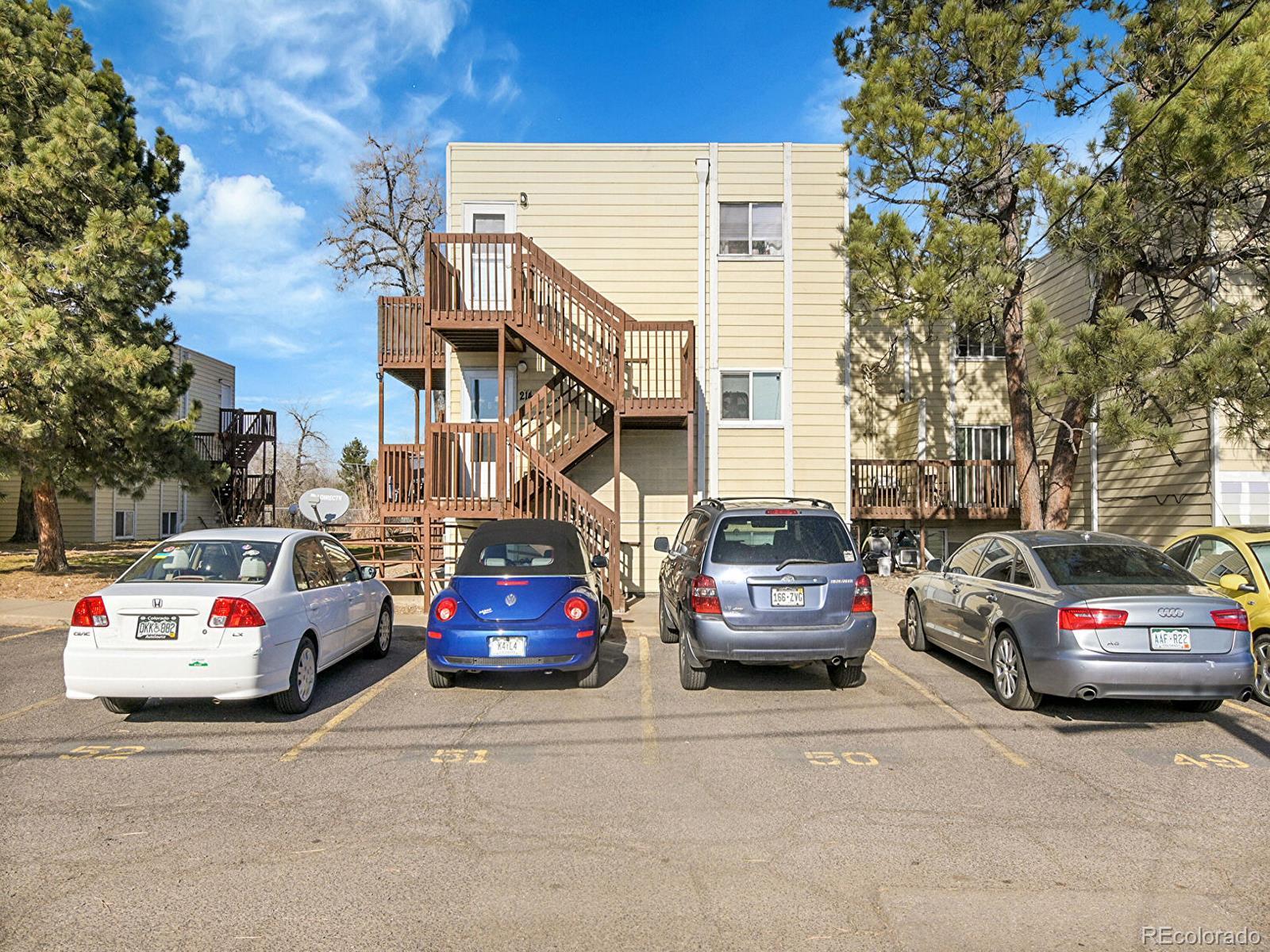 9340 West 49th Avenue, Unit 218 Wheat Ridge, CO 80033 - Photo 23 of 31 a view of a cars parked in front of a house