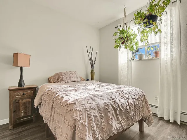 a bed sitting in a bedroom next to a window