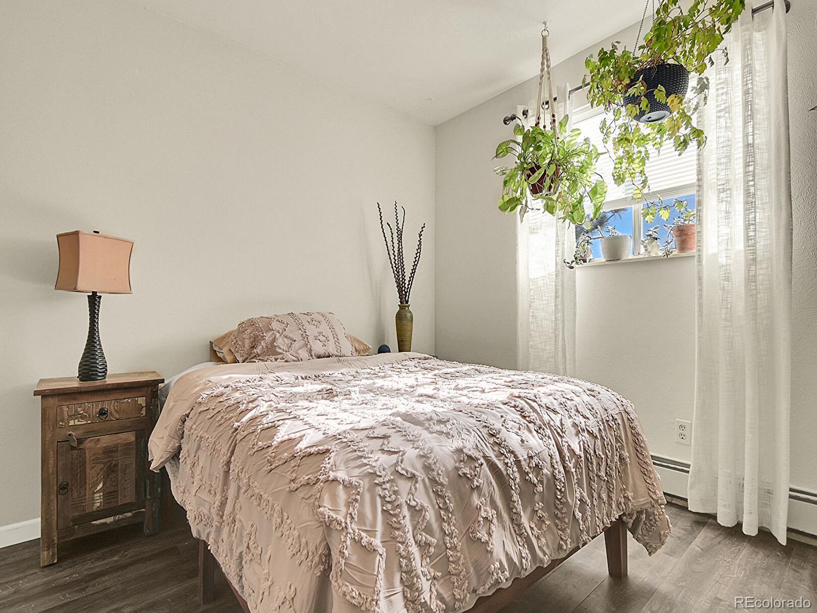 9340 West 49th Avenue, Unit 218 Wheat Ridge, CO 80033 - Photo 26 of 31 a bed sitting in a bedroom next to a window