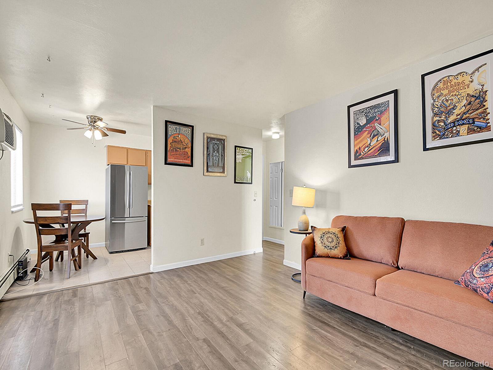 9340 West 49th Avenue, Unit 218 Wheat Ridge, CO 80033 - Photo 27 of 31 a living room with furniture and wooden floor