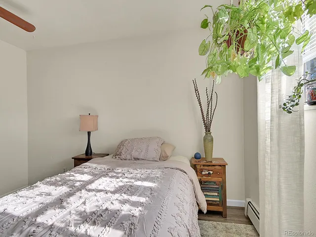 a bedroom with a bed and a plant