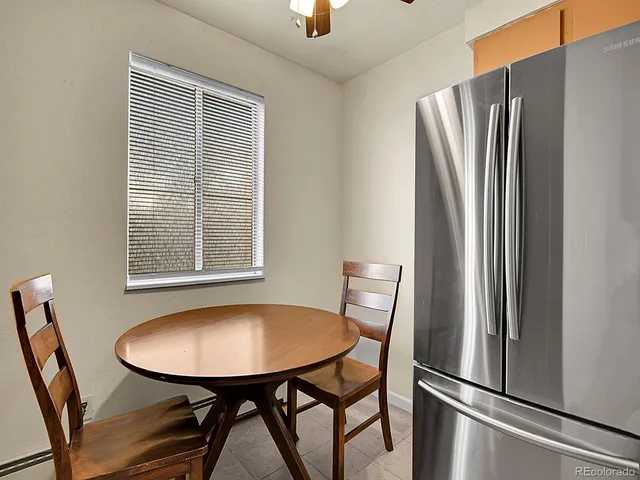 a view of a dining room with furniture and window