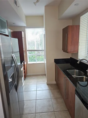 a kitchen with a sink a counter top space and stainless steel appliances