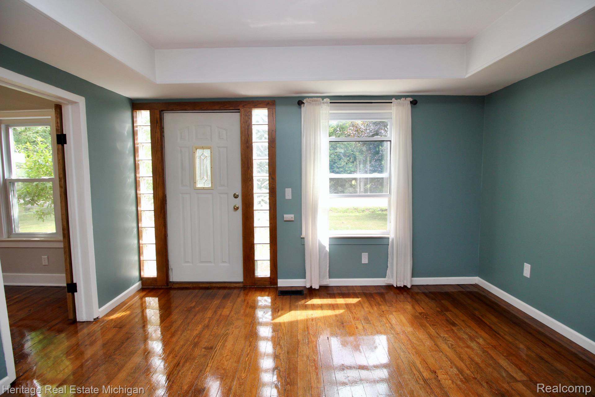 15352 South Duffield Road Byron, MI 48418 - Photo 11 of 47 Entryway featuring wood-finish flooring, a white door with decorative glass insert, and side light panels