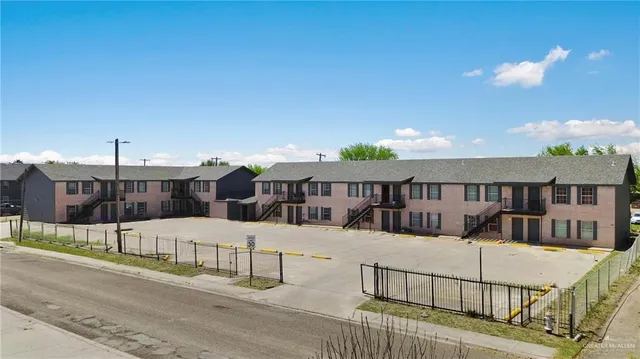a view of a house with wooden fence