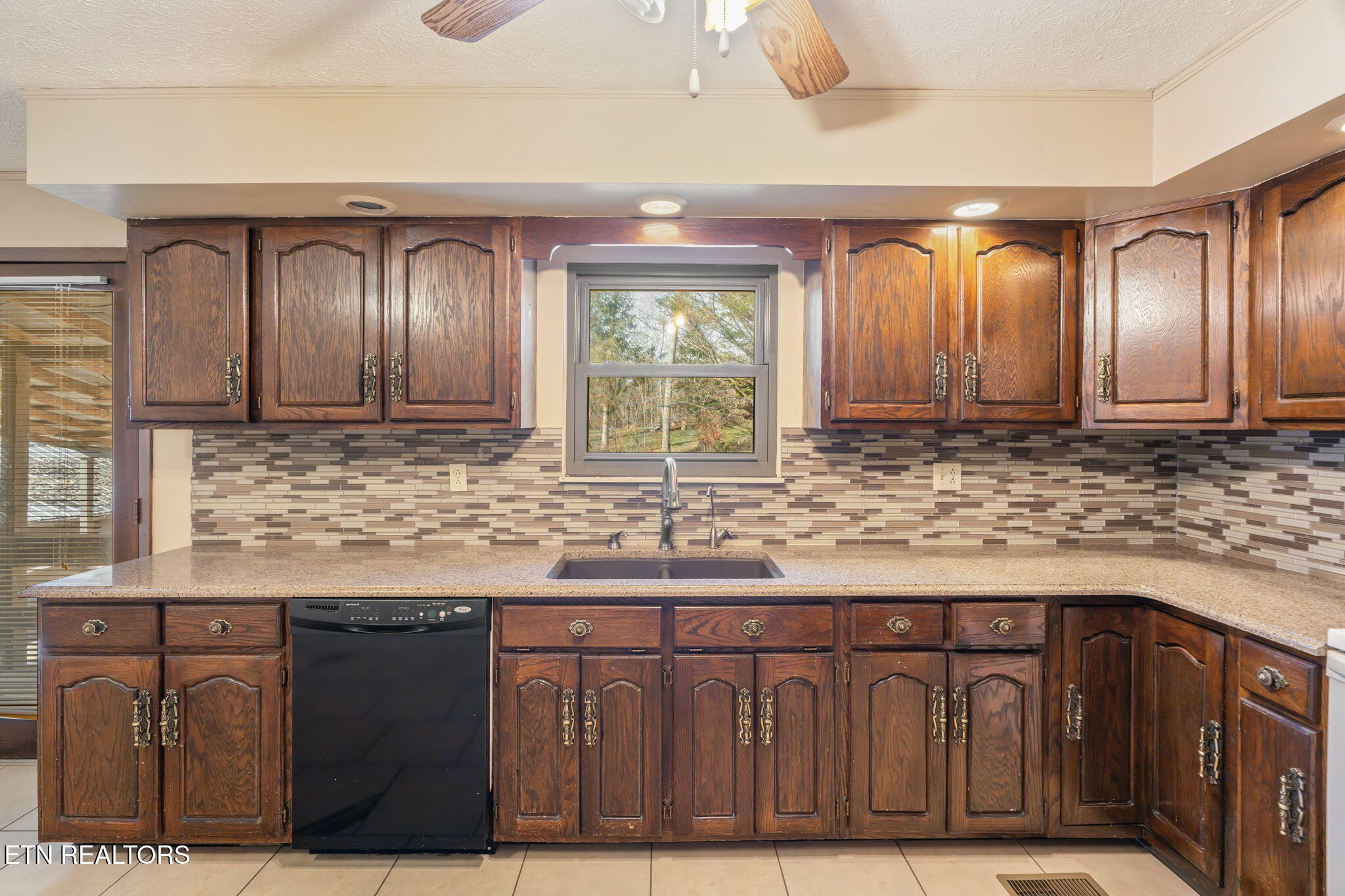115 Jamie Street Maynardville, TN 37807 - Photo 15 of 58 a kitchen with granite countertop a sink and a wooden cabinets