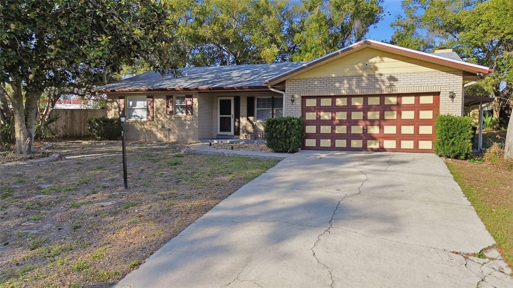 244 Angeles Road DeBary, FL 32713 - Photo 6 of 41 a front view of a house with a garden and plants
