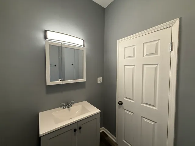 a bathroom with a sink a mirror and a toilet