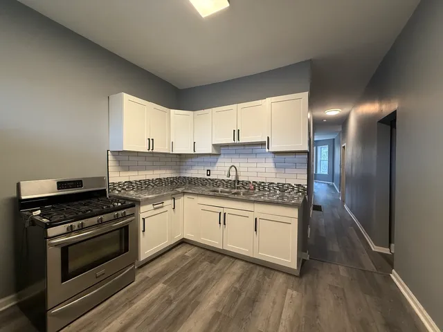 a kitchen with stainless steel appliances granite countertop a stove and a refrigerator