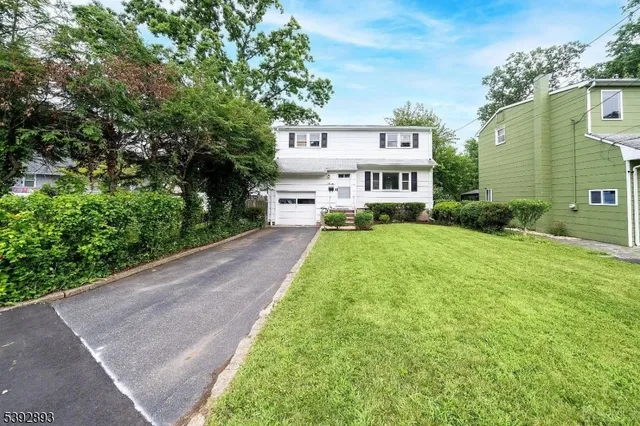 a view of a house with a yard and plants