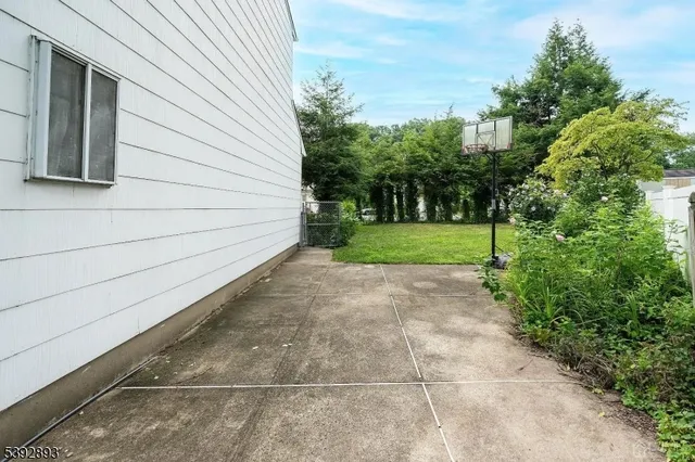 a backyard of a house with lots of green space and fountain