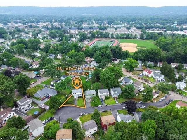 an aerial view of multiple houses with yard