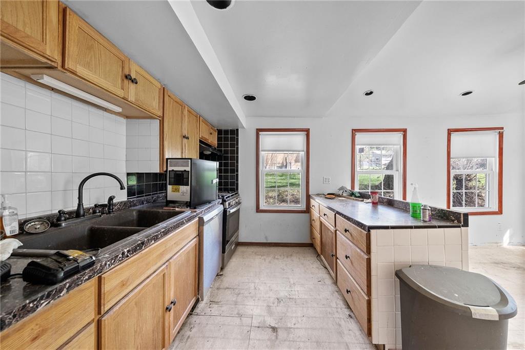 404 Middle Street Pittsburgh, PA 15227 - Photo 7 of 33 a large kitchen with stainless steel appliances a sink stove and cabinets
