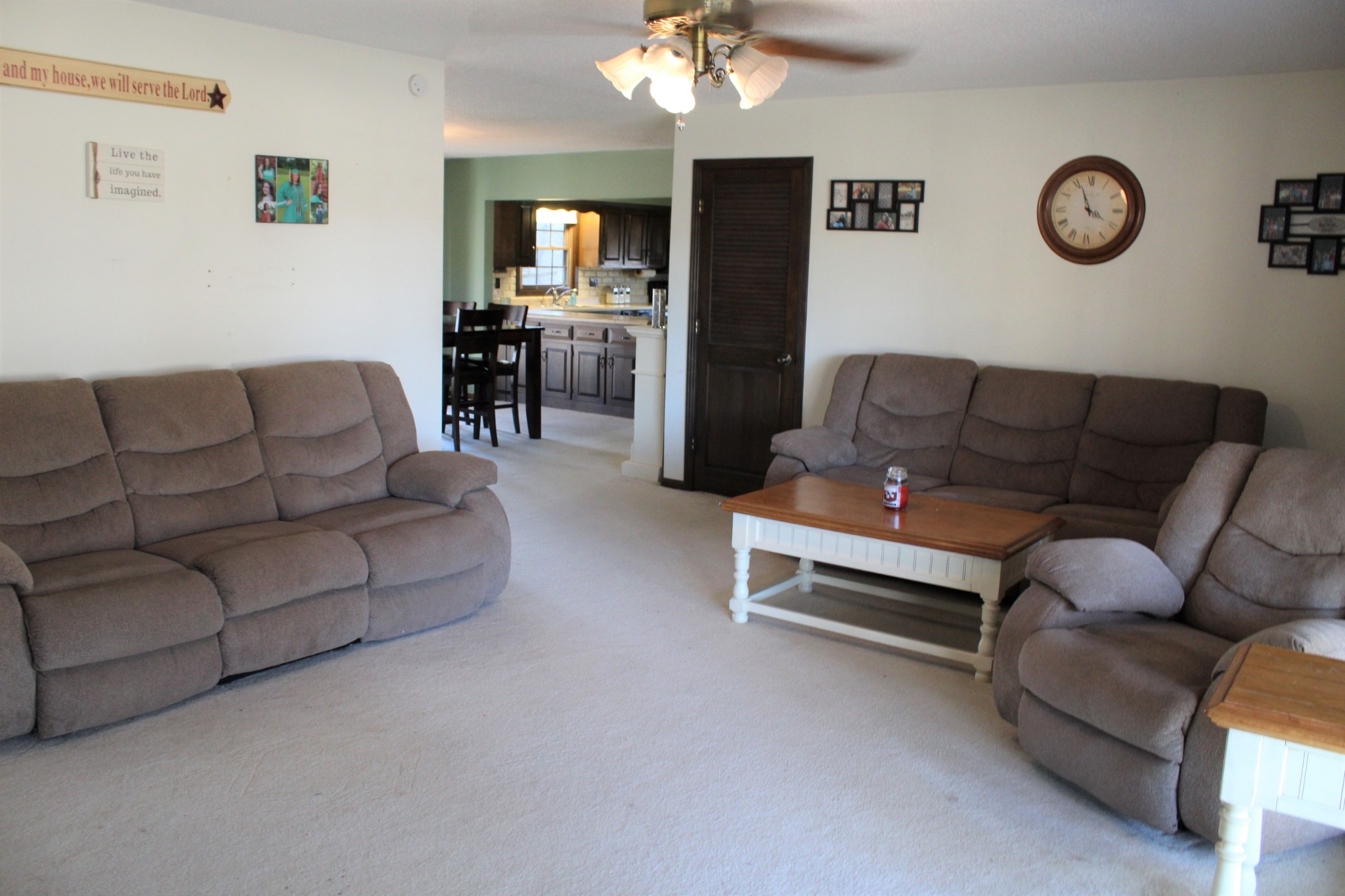 4165 Buckeye Road Cumberland City, TN 37050 - Photo 4 of 20 a living room with furniture a flat screen tv and a wall clock