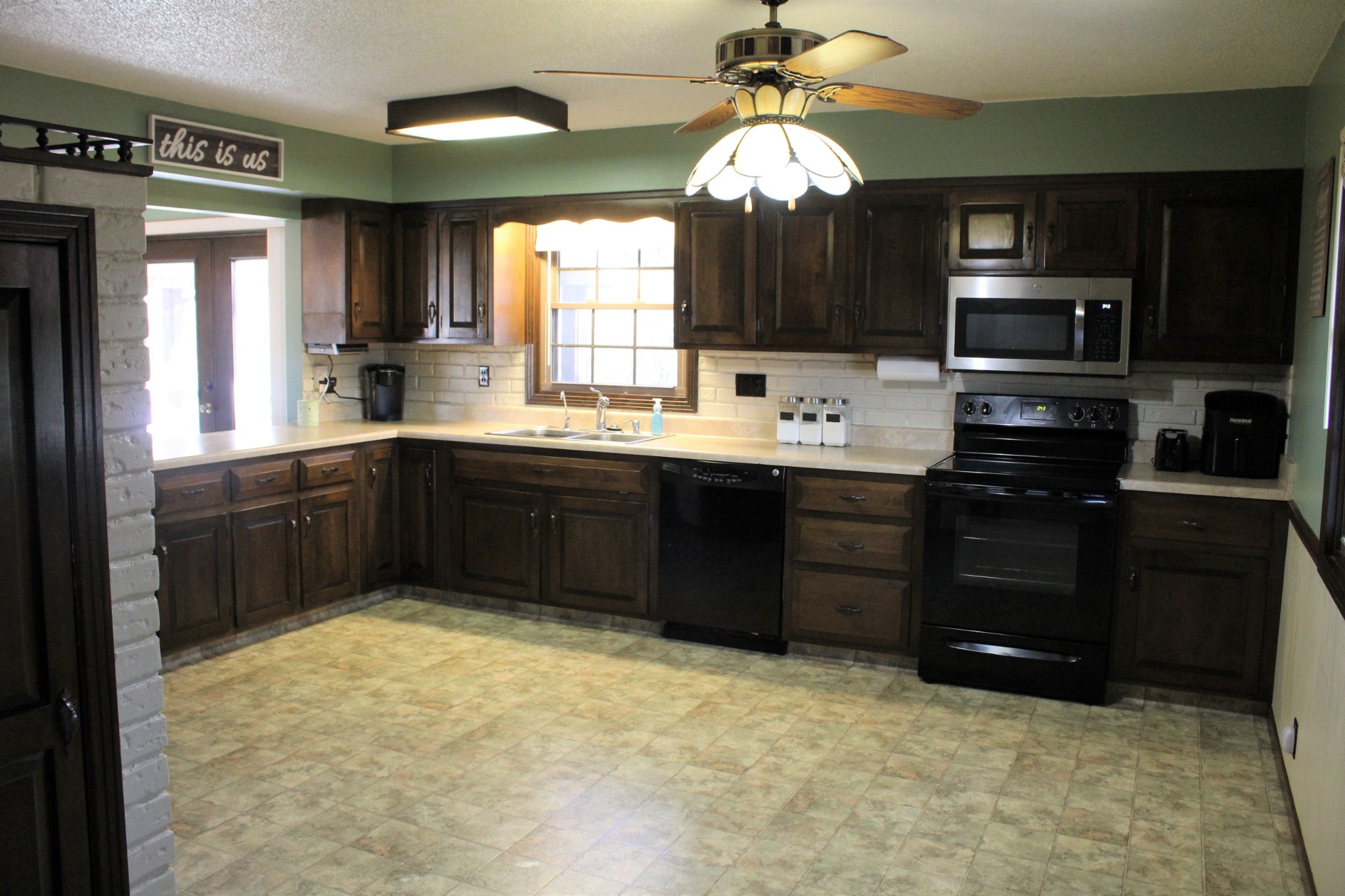 4165 Buckeye Road Cumberland City, TN 37050 - Photo 7 of 20 a kitchen with a sink stove and microwave