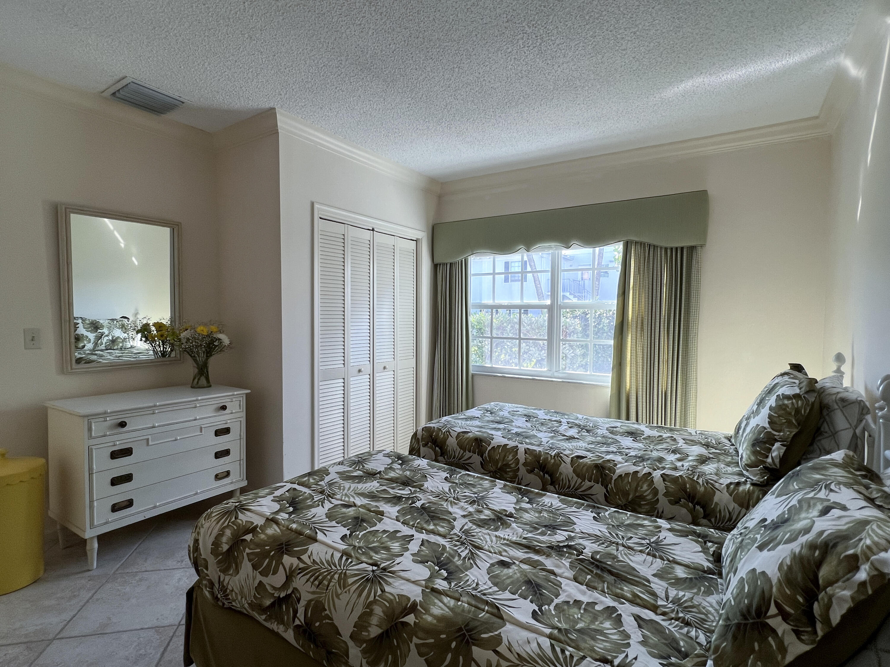 400 South Ocean Boulevard, Unit 103A Lake Worth, FL 33462 - Photo 11 of 12 a bedroom with a bed and a dresser