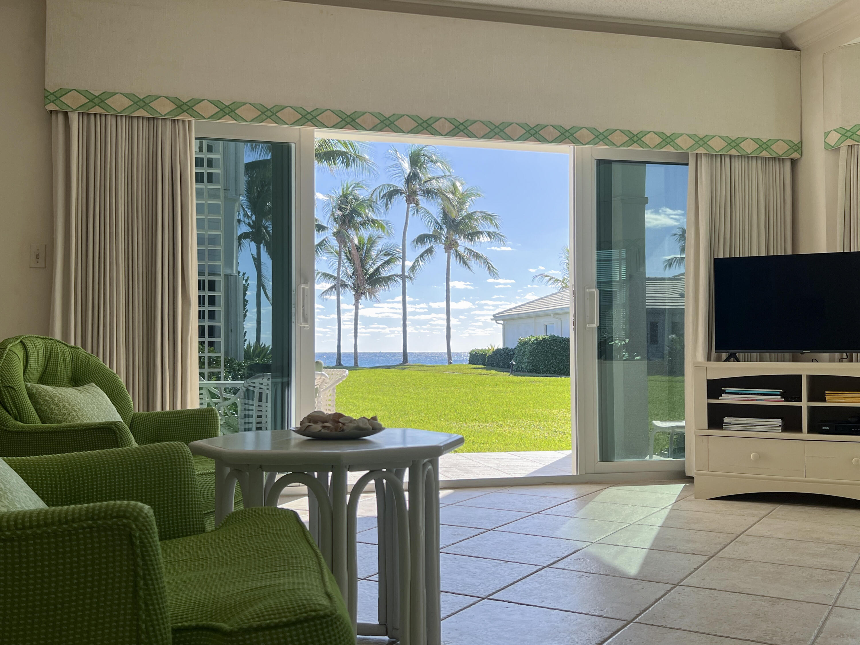 400 South Ocean Boulevard, Unit 103A Lake Worth, FL 33462 - Photo 5 of 12 a living room with furniture and a flat screen tv