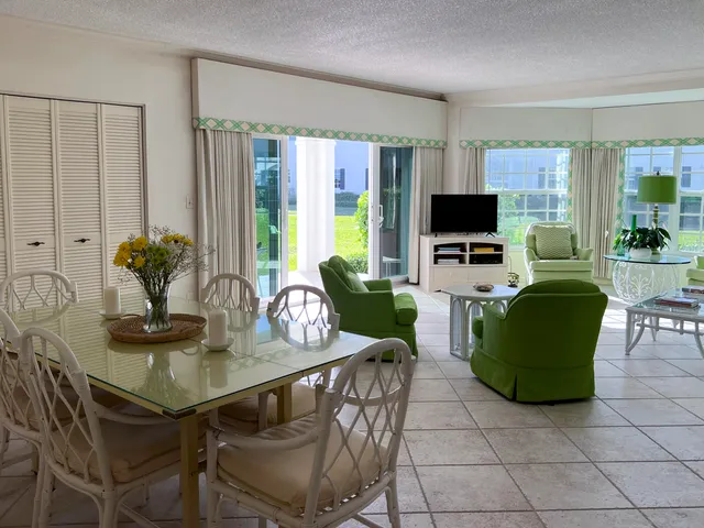 a bathroom with a granite countertop toilet sink and mirror