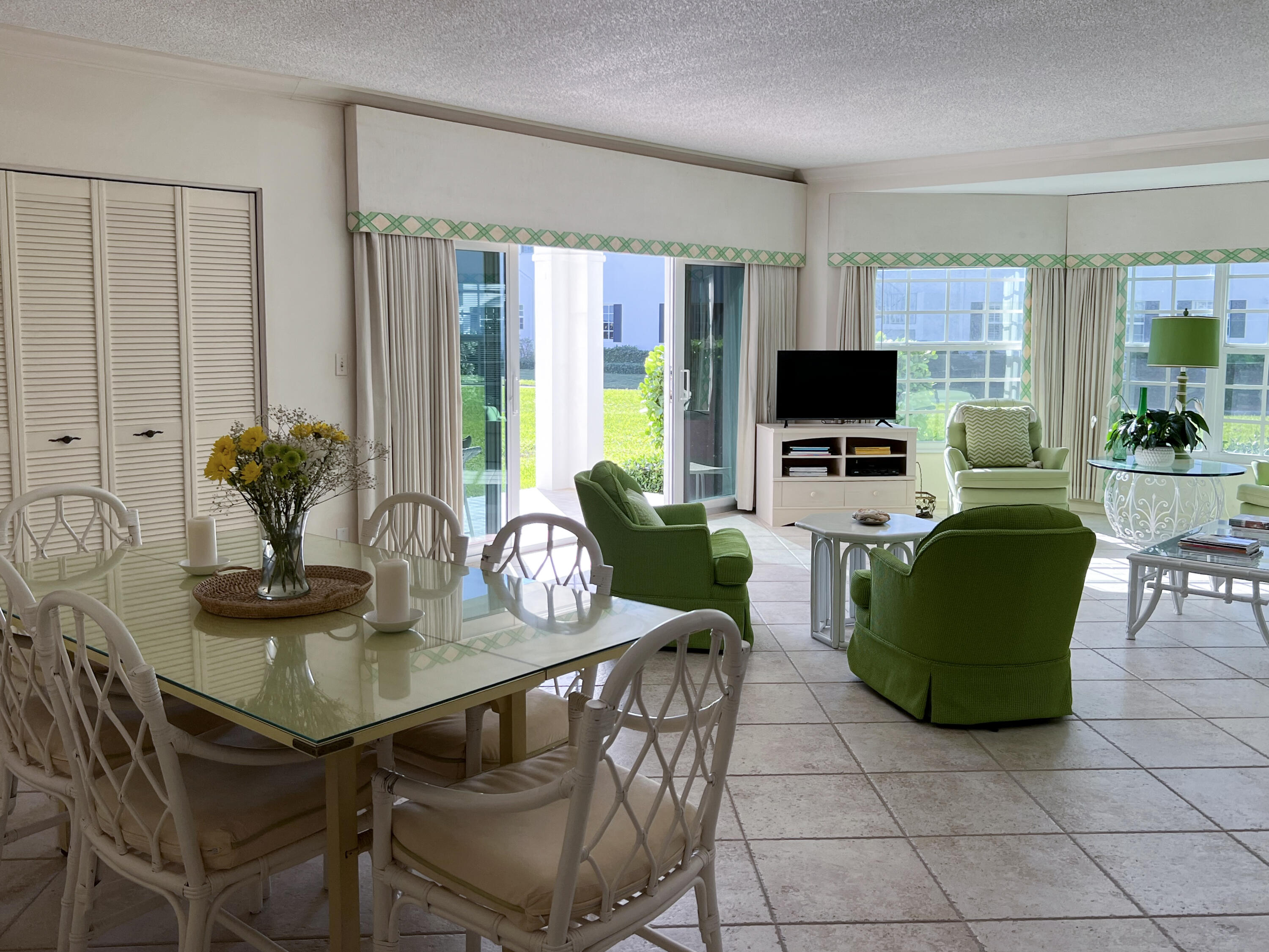 400 South Ocean Boulevard, Unit 103A Lake Worth, FL 33462 - Photo 6 of 12 a view of a livingroom with furniture and a flat screen tv