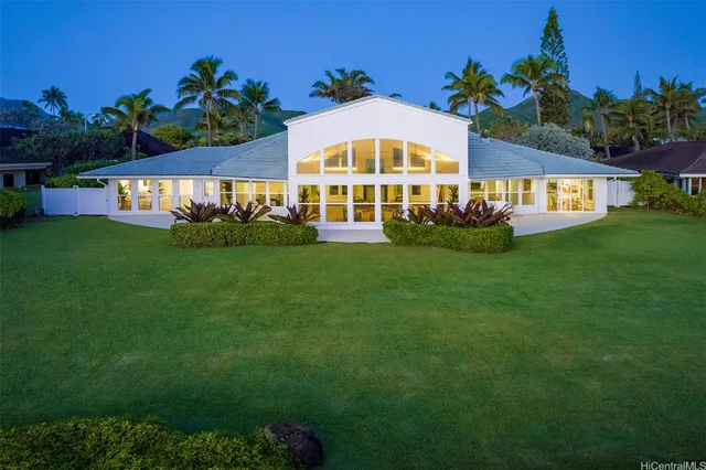 a front view of a house with a garden and a yard