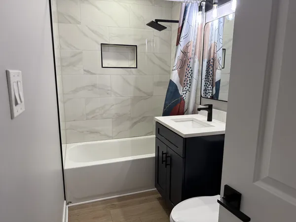 a bathroom with a sink toilet and shower