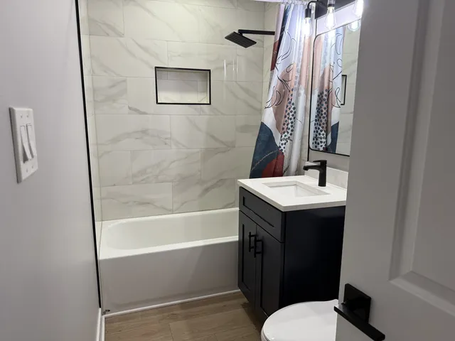 a bathroom with a sink toilet and shower