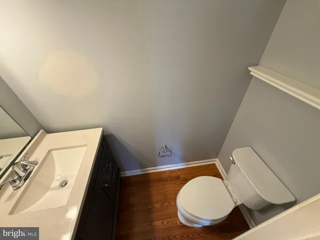 a bathroom with a toilet and a mirror