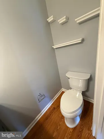 a white toilet sitting next to a shower
