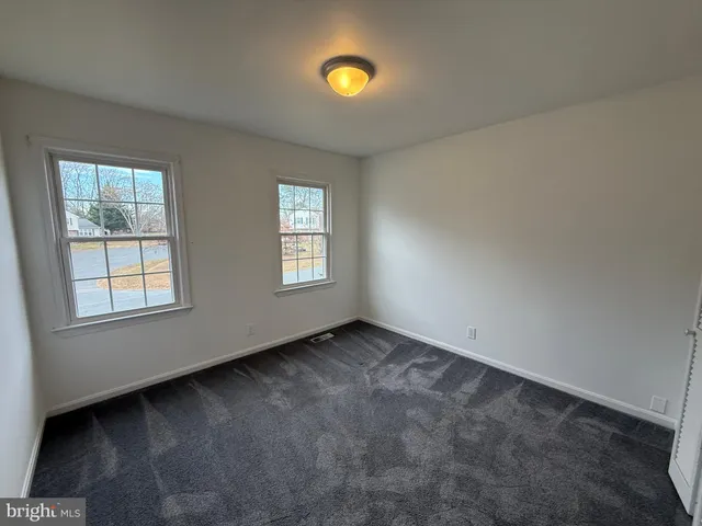 an empty room with windows and window