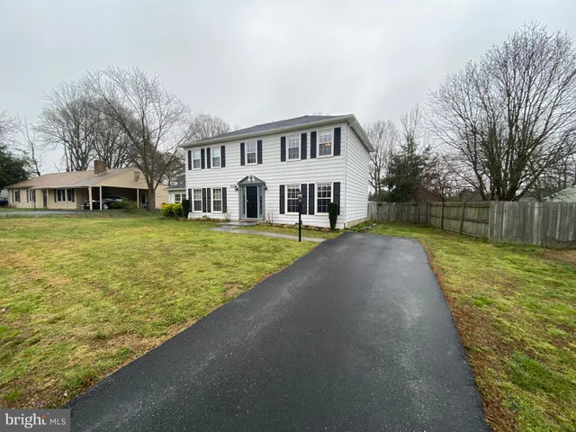 a view of swimming pool with outdoor seating and house in the background